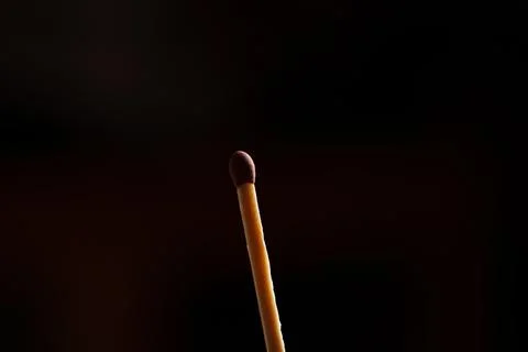 Brown match on black background Stock Photos
