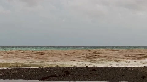 Brown Mountain River Flows Into the Blue Sea. Italy. Stock Footage 221654328