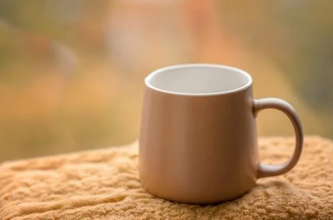 Brown mug by the window. Stock Photos