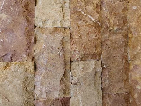 Brown natural stone wall texture background with rough surface Stock Photos