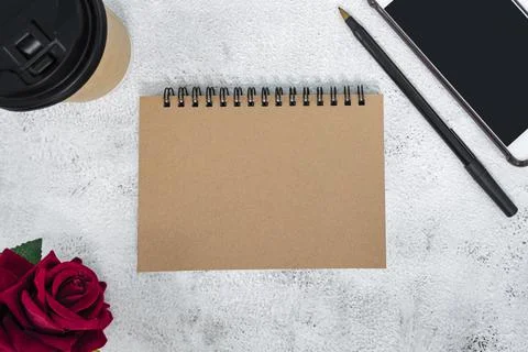 Brown note book on marble desk. Directly above. Flat lay. Copy space. Stock Photos