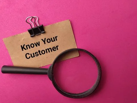A brown note labeled Know Your Customer clipped with a binder clip rests ab.. Stock Photos
