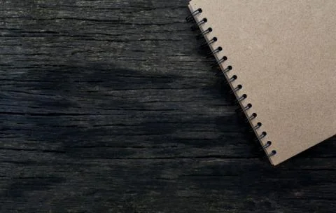 Brown notebook on wood background Stock Photos
