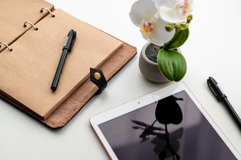 The brown notepad lies on the office table. Stock Photos