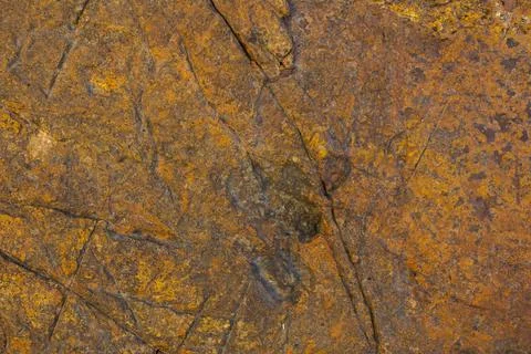 Brown orange gray stone with deep scratches. rough natural texture surface Stock Photos