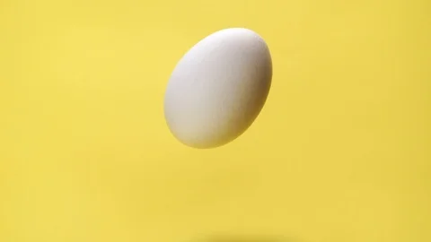 Brown paint flowing on egg howering in air Stock Footage 104566771