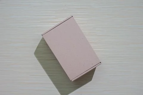 A brown paper box isolated on a table, perfect for packaging or gifting, of.. Stock Photos