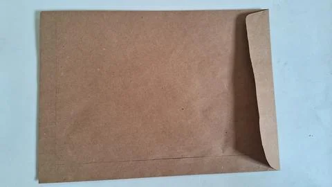 Brown paper envelope on white background. Recycled cardboard mailer for business Stock Photos