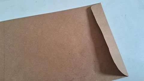 Brown paper envelope on white background. Recycled cardboard mailer for business Stock Photos