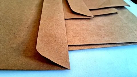 Brown paper envelopes on white background. Recycled cardboard mailers for office Stock Photos