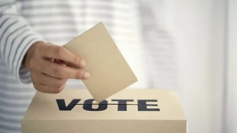 Brown paper insert in vote box, bright future of democracy concept Stock Footage 107518447