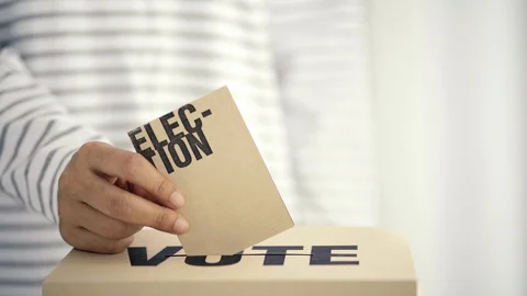 Brown paper insert in vote box, bright future of democracy concept Stock Footage 107518604