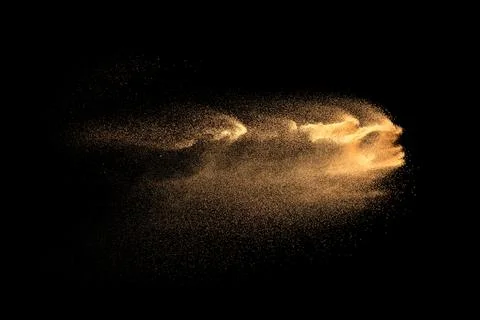 Brown particles dust splash on black background. Brown dust explosion. 스톡 일러스트