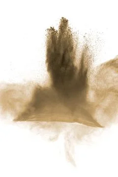 Brown particles splattered on white background. Brown dust splashing. Stock Photos