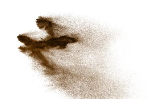 Brown particles splattered on white background. Brown dust splashing. Stock Photos