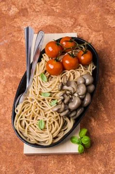 Brown pasta with vegetables Stock Photos