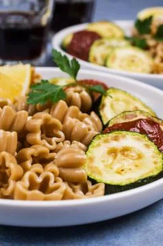 Brown pasta with vegetables Stock Photos