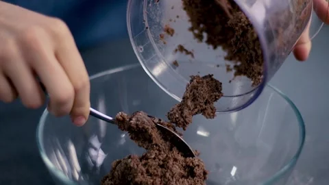 Brown paste with a legume beans, spices, oil pour out of blender with a spoon Stock Footage 135236636