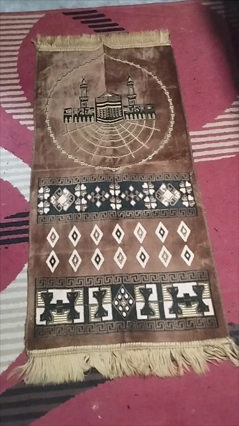 The brown patterned prayer mat is very beautiful Stock Footage 293056524