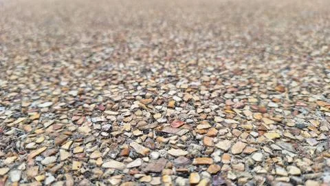 Brown pebble stone ground texture with shallow depth focus Stock Photos