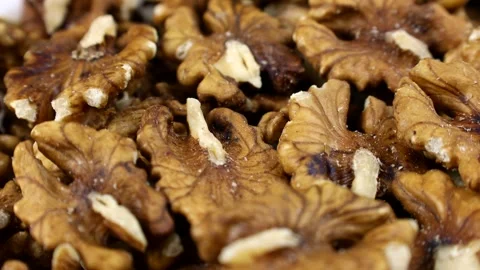 Brown peeled walnut nuts pieces circle rotation close up Stock Footage 274909643