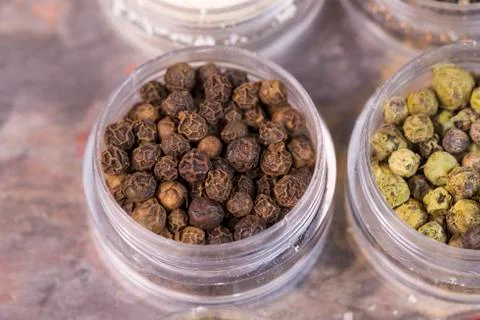 Brown peppercorns in container Stock Photos