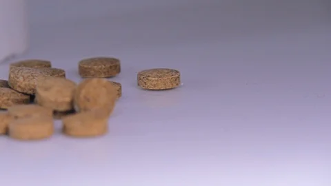 Brown pills, close up, slide left on a white background Stock Footage 129607078