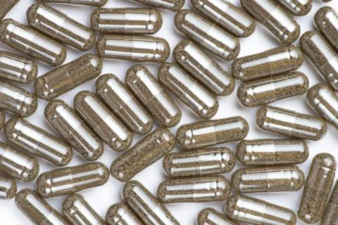 Brown pills, tablets on white background. Close-up photography of tablets or Stock Photos