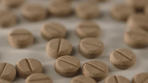 Brown pills on the turntable Stock Footage 249973662