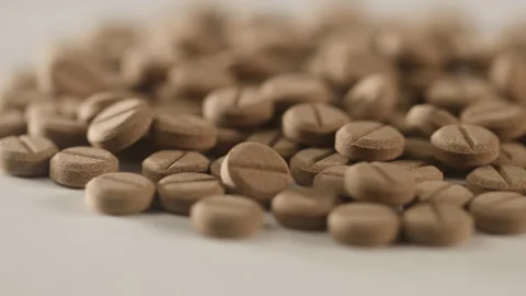 Brown pills on the turntable Stock Footage 249973709