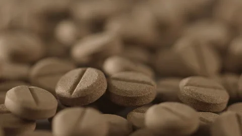 Brown pills on the turntable Stock Footage 249973720
