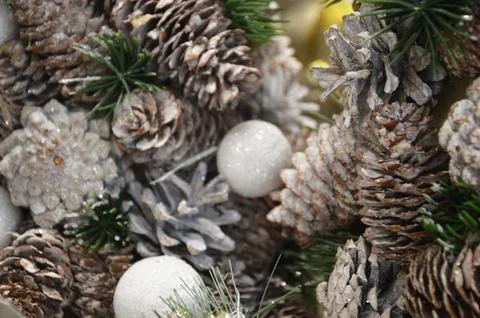 Brown pine cones and silver balls covered with frost on a Christmas tree. Fes Stock Photos
