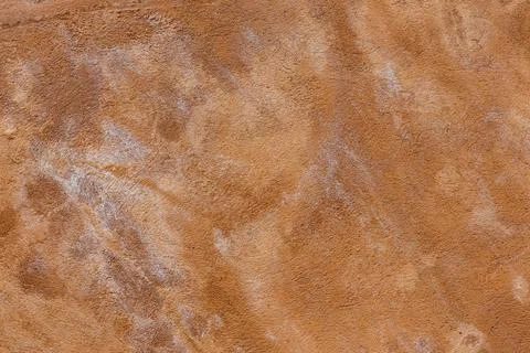 Brown plaster wall texture with white salt stains Stock Photos
