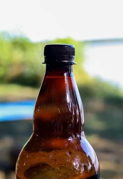 A brown plastic bottle with a drink inside Fotos de archivo