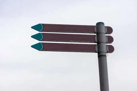 Brown pointers on a pole against the sky Stock Photos