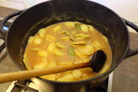 Brown potatoes in the pot Stock Photos