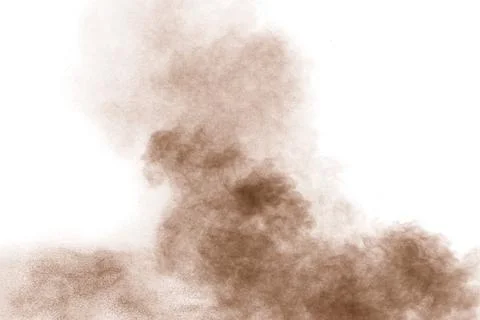 Brown powder dust cloud.Brown particles splattered on white background. Stock Photos