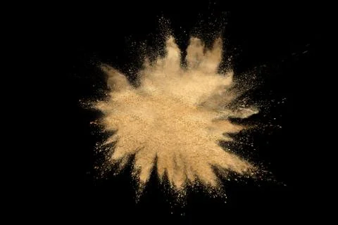 Brown powder explosion on black background. Illustrazione stock