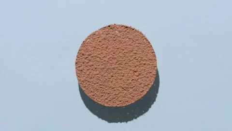 Brown powder sifting in circle with morphing shadows 스톡 동영상 338349539