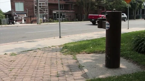Brown public double water drinking fountain with second leveraged out on cement Stock Footage 247749260