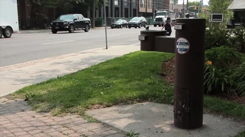 Brown public double water drinking fountain with second leveraged out on cement Stock Footage 247749304