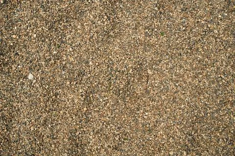 Brown quarry sand layer close-up with uneven mineral grain density, highlig.. Stock Photos