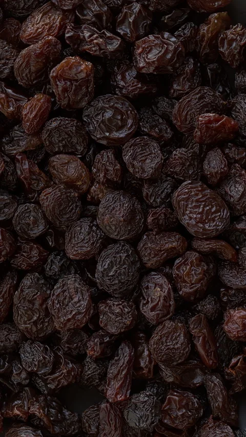 Brown raisins background texture. Vertical video. Stock Footage 308746796