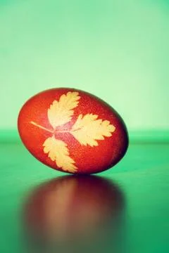Brown-red Easter grass decorated egg colored with onion infusion Stock Photos