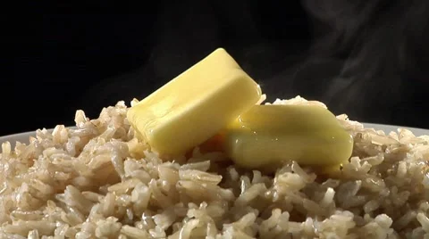 Brown rice with knobs of butter Stock Footage 8574010