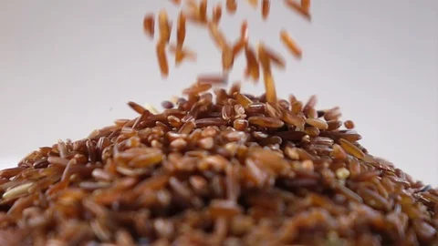 Brown rice pouring on stack slow motion Video stock 102216359