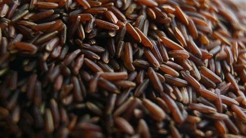 Brown rice rotates in motion close up Stock Footage 128227708