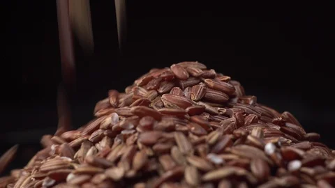 Brown rice spin on table and rice fall down on it. Nice cinematic footage. Stock Footage 127003596