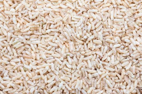 Brown rice uncooked for use as a background. Stock Photos