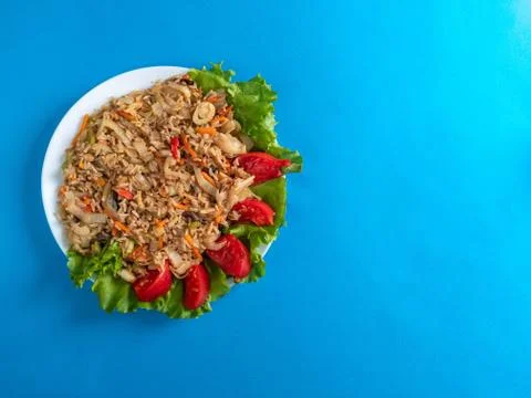 Brown rice with vegetables on a blue background Stock Photos